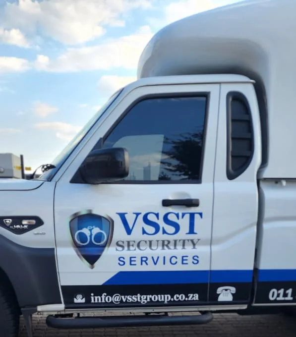 Side of a white VSST bakkie with the VSST Security Services logo