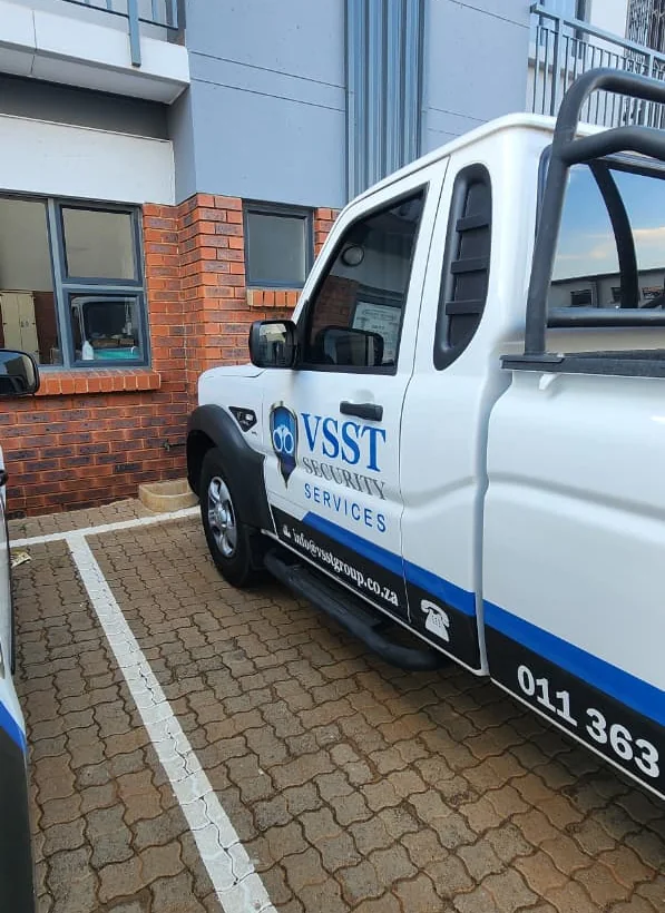 White VSST Security Services bakkie with company branding